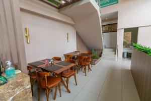 a row of tables and chairs in a restaurant at Manaíra Apart Flat in João Pessoa