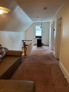 a living room with a couch and a window at Rothesay Motel in Rothesay