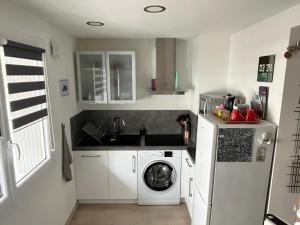 a kitchen with a washing machine and a washer at Lovely Studio Cannes in Cannes
