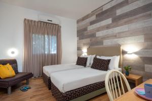 a hotel room with a bed and a table at Kibbutz Malkiya Travel Hotel in Malkiyya