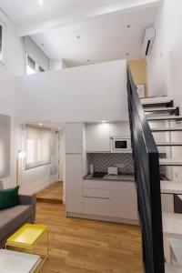 a living room with a couch and a kitchen at El Duplex de Barrocal in Cádiz +6 photos