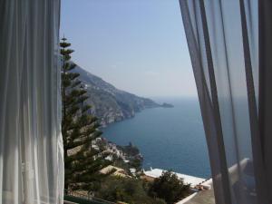 a view of the ocean from a hotel room window at casa Lux in Praiano