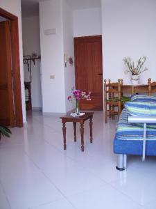 a room with a table with a vase of flowers on it at casa Lux in Praiano