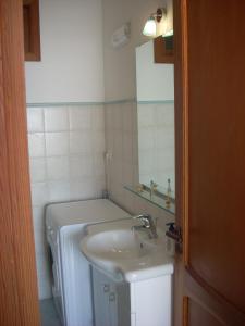 a bathroom with a sink and a washing machine at casa Lux in Praiano