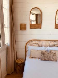 a bedroom with a white bed with a mirror at Hôtel Le Britannic - centre gare- in Saint Malo