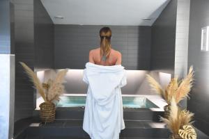 a woman is standing in a bath tub at Royal Antibes - Luxury Hotel, Résidence, Beach & Spa in Antibes