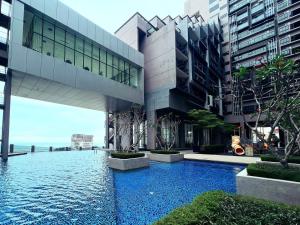 a building with a swimming pool in front of it at Imperio Residences Melaka Malacca in Melaka