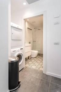 a bathroom with a washing machine and a toilet at Modern and Design 1 BD apt close to the beach in Tel Aviv
