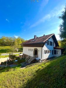 a white house with a porch and a yard at Schweizerhaus am Kurpark in Boppard