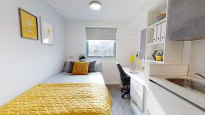 a bedroom with a bed and a desk and a sink at Modern and Stylish Studio Apartments at Westcombe House in Greenwich in London