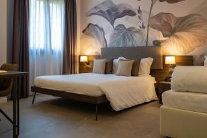 Postel nebo postele na pokoji v ubytování Hotel Ulivi