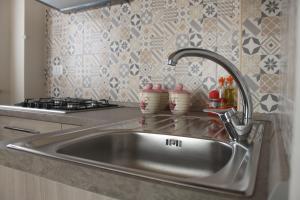 a stainless steel sink in a kitchen at Casa Vacanze Zia Concetta in Nardò +48 photos