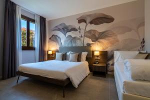 Postel nebo postele na pokoji v ubytování Hotel Ulivi + 37 fotografií