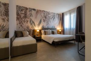Postel nebo postele na pokoji v ubytování Hotel Ulivi