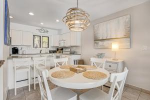 a kitchen and dining room with a white table and chairs at Sea Colony --- 3003C West Lake Ct in Bethany Beach