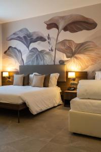 Postel nebo postele na pokoji v ubytování Hotel Ulivi