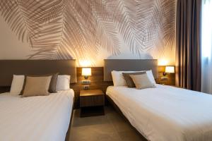 Postel nebo postele na pokoji v ubytování Hotel Ulivi