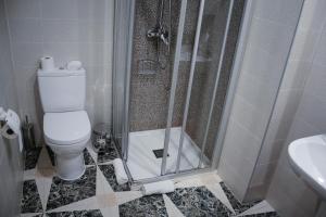 a bathroom with a shower and a toilet and a sink at El Tossal in El Castell de Guadalest