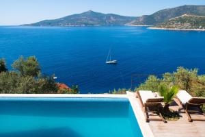 a swimming pool with a view of a body of water at Hotel Villa Mahal in Kalkan
