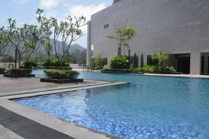 a swimming pool in front of a building at Pool View Casa Suite 5pax Midhill Genting Highlands in Genting Highlands