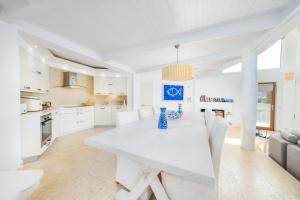 a kitchen and dining room with a white table and chairs at Hotel Villa Mahal in Kalkan