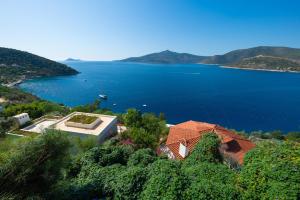 a house with a view of a large body of water at Hotel Villa Mahal in Kalkan