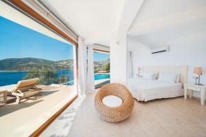 a bedroom with a bed and a view of the ocean at Hotel Villa Mahal in Kalkan