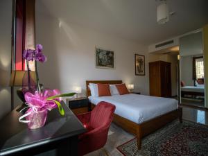A bed or beds in a room at Ego' Residence Ferrara
