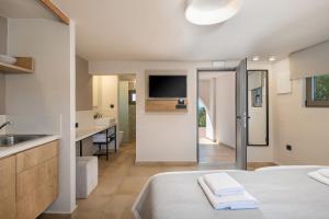 a hotel room with a bed and a sink at Elafonisi Resort by Kalomirakis Family in Elafonisi