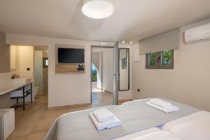 a bedroom with a bed with two towels on it at Elafonisi Resort by Kalomirakis Family in Elafonisi