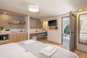 a bedroom with a bed with two towels on it at Elafonisi Resort by Kalomirakis Family in Elafonisi