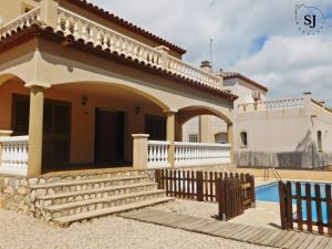 una villa con piscina e una casa di Chalet con piscina (B) a Les tres Cales