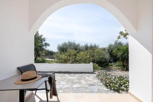 an archway with a table and a hat at Elafonisi Resort by Kalomirakis Family in Elafonisi