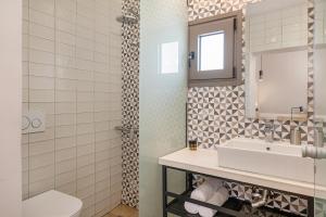 a bathroom with a sink and a mirror at Elafonisi Resort by Kalomirakis Family in Elafonisi