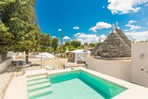 a swimming pool in the backyard of a house at Trullo Pioppo gigante - jacuzzi in San Michele Salentino