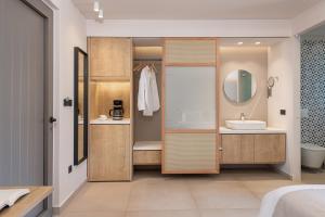 a bathroom with a sink and a mirror at Elafonisi Resort by Kalomirakis Family in Elafonisi