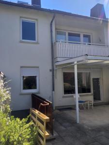 a white house with a balcony and a patio at Pension Rückert in Kassel