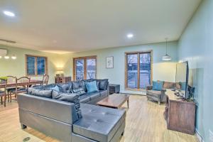 a living room with a couch and a table at Honeoye Lake House with Community Amenities! in Honeoye