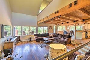 a living room with a couch and a table at Secluded Home in Natl Forest with Fire Pit! in Auberry