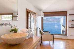 a kitchen with a large bowl on a table with a large window at Hotel Villa Mahal in Kalkan