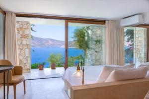 a bedroom with a view of the ocean at Hotel Villa Mahal in Kalkan
