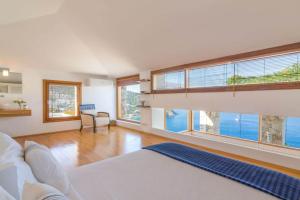 a large living room with large windows and a couch at Hotel Villa Mahal in Kalkan