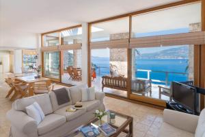 a living room with a couch and a television at Hotel Villa Mahal in Kalkan