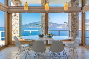 a dining room with a table and chairs at Hotel Villa Mahal in Kalkan