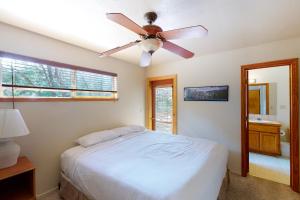 a bedroom with a bed and a ceiling fan at Streiff Lake House in Bass Lake