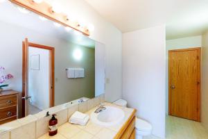 a bathroom with a sink and a mirror at Streiff Lake House in Bass Lake +16 photos