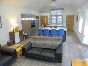 a living room with a couch and a kitchen at Lynnfield Hall in Hunstanton