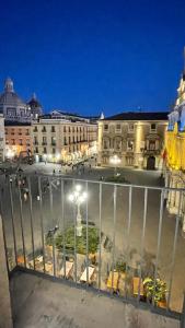 a view from a balcony of a city at night at B&B Doralice in Catania