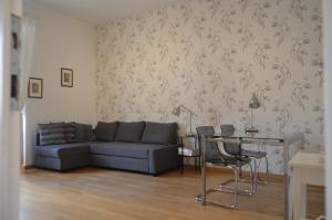a living room with a couch and a table with chairs at Blue Star luxury apartment San Giovanni - Colosseo in Rome