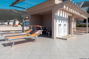 a patio with a ping pong table on a roof at Petrovac Holiday Apartments in Petrovac na Moru